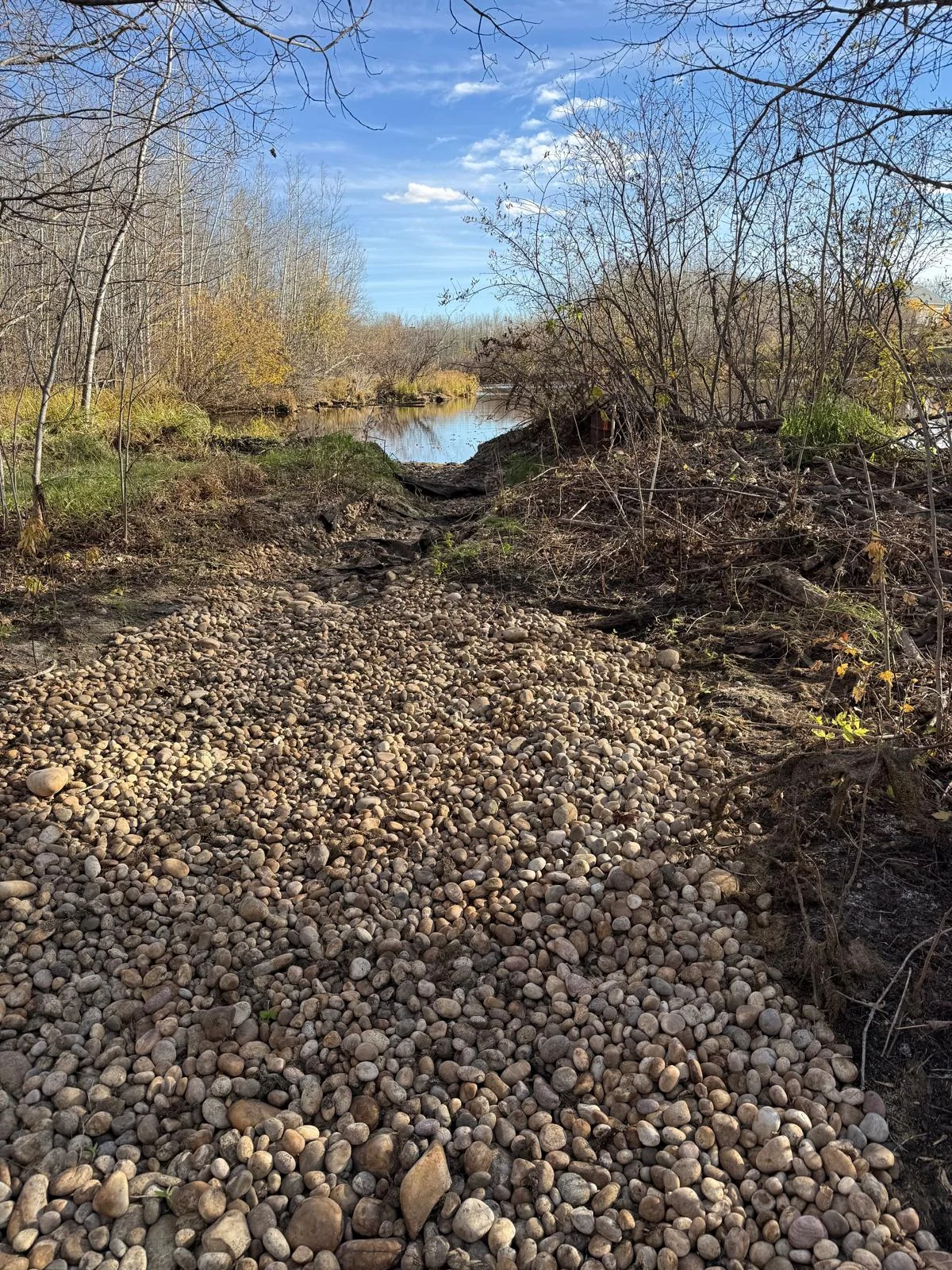 Stone-lined area leading toward a waterway