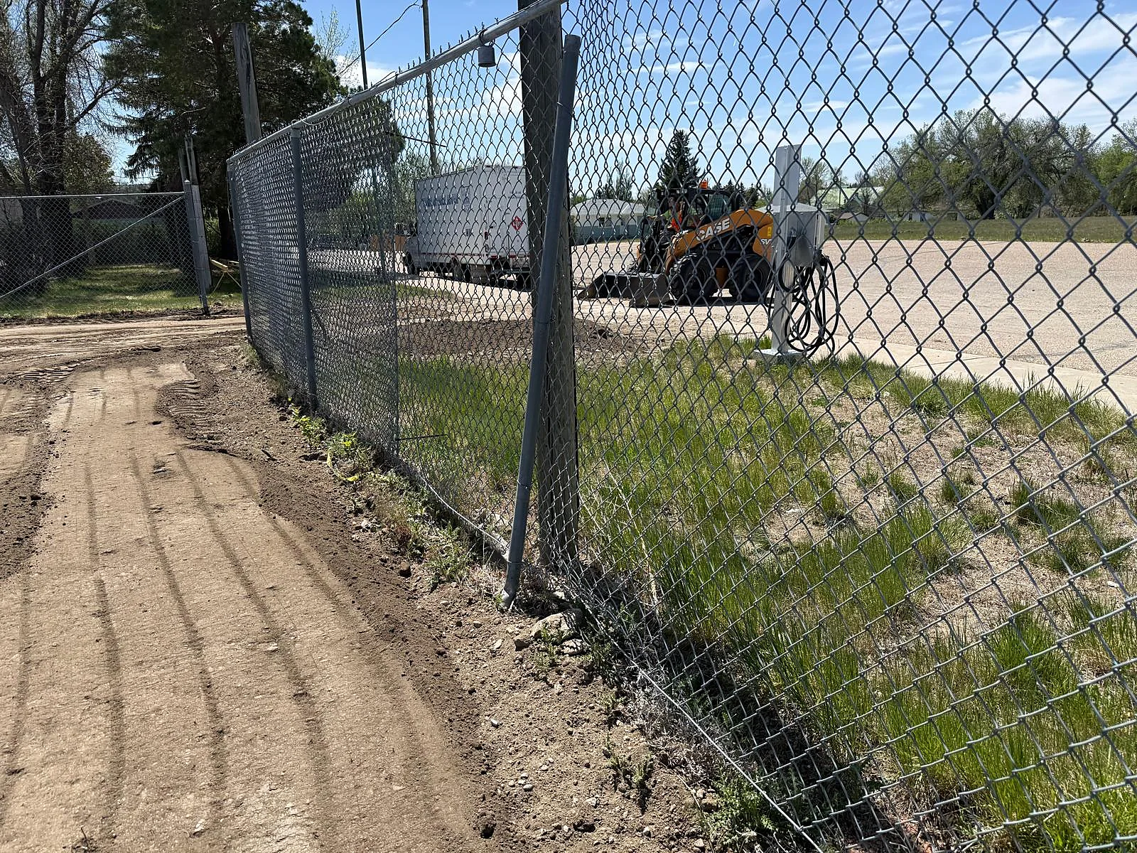 Perimeter grading and ground preparation beside site fence