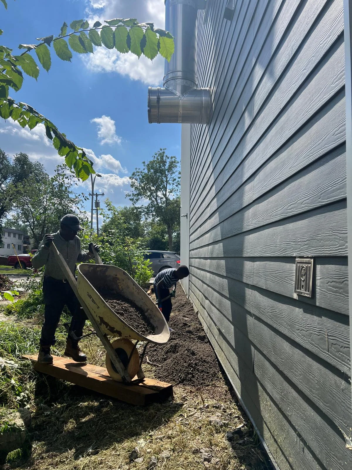 Moving soil and preparing ground levels beside the building