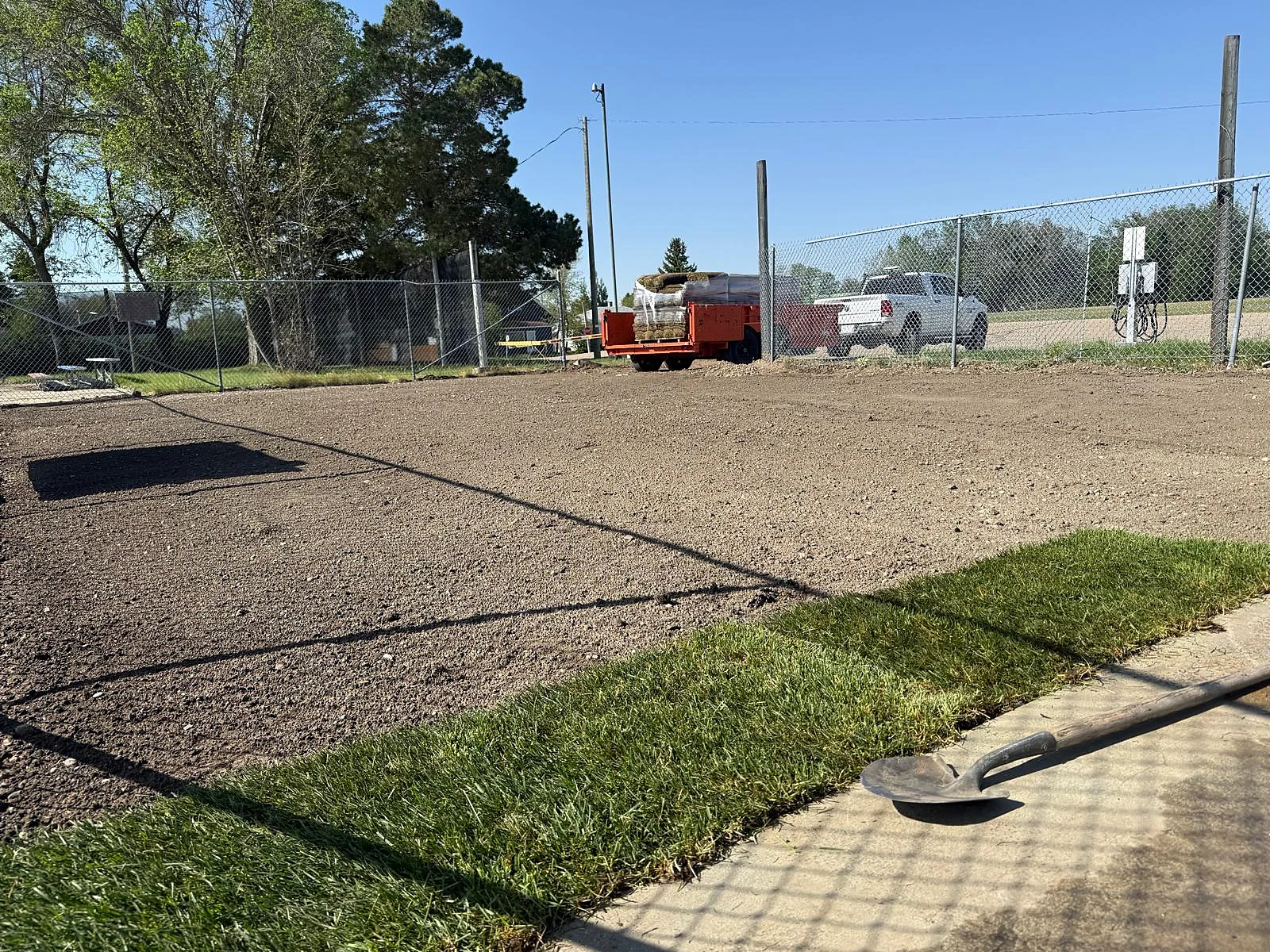 Prepared grades and fresh sod installation at outdoor site