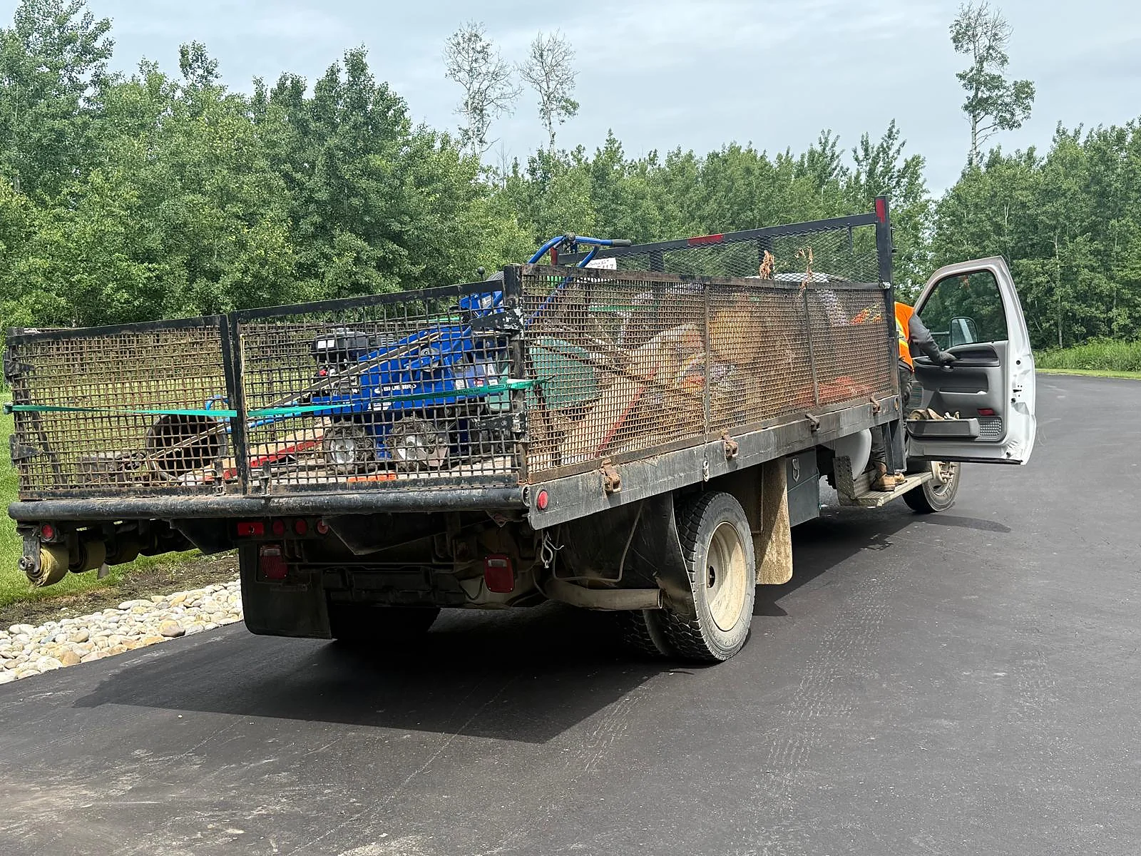 Work truck loaded with landscaping machinery and materials
